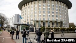 NETHERLANDS -- Journalists wait outside the headquarters of the Organisation for the Prohibition of Chemical Weapons (OPCW) in The Hague, April 4, 2018