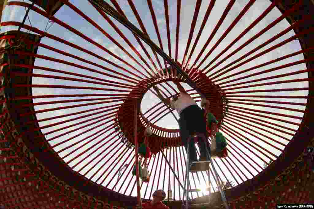 Kyrgyz men assemble a yurt in preparation for a cultural festival on the central square of Bishkek. The yurt is a traditional round tent used by the nomads of Central Asia&#39;s steppes and consists of a wooden frame covered with felt or skins.