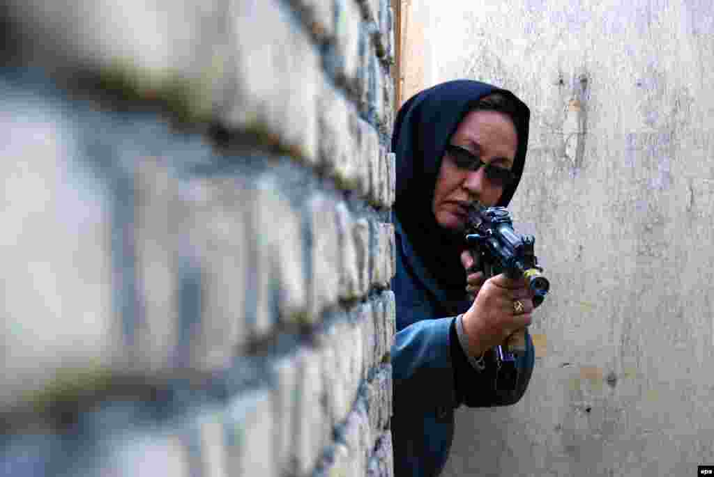 An Afghan police official shows off her skills during a training session in Mazar-e Sharif. (epa/Sayed Mustafa)