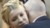 Yulia Tymoshenko is embraced by her husband Oleksandr after her conviction is announced. 