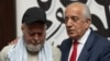 US citizen Dennis Coyle (left), upon his release by the Taliban, addresses the media with US former special envoy to Afghanistan Zalmay Khalilzad at the airport in Kabul on March 24.