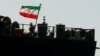 A crew member raises the Iranian flag on Iranian oil tanker Adrian Darya 1 in mid-August while in Gibraltar.