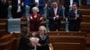 Kosovo's new President Justina Pula receives a bouquet of flowers after being elected in an extraordinary parliamentary session in Pristina.