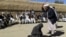An Afghan judge hits a woman with a whip in front of a crowd in Ghor Province in 2015. (illustrative photo)