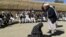 An Afghan judge hits a woman with a whip in front of a crowd in Ghor Province. (file photo)