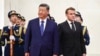 Chinese leader Xi Jinping standing next to French President Emmanuel Macron during a welcome ceremony in Beijing on December 4