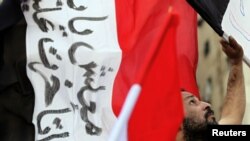 A protester holds an Egyptian flag during a protest in Cairo in early February.