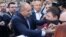 Bulgarian President Rumen Radev (left) came out and thanked protesters for their support. 