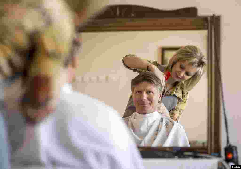 Russian cosmonaut Gennady Padalka gets his hair cut at the Cosmonaut Hotel in the Baikonur cosmodrome on March 25. (Reuters/​Bill Ingalls)