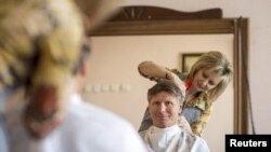 Russian cosmonaut Gennady Padalka gets his hair cut while he on Earth earlier this year. 