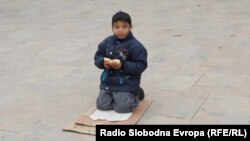 Macedonia - Beggar sitting in a street, Skopje, 30 January 2014.
