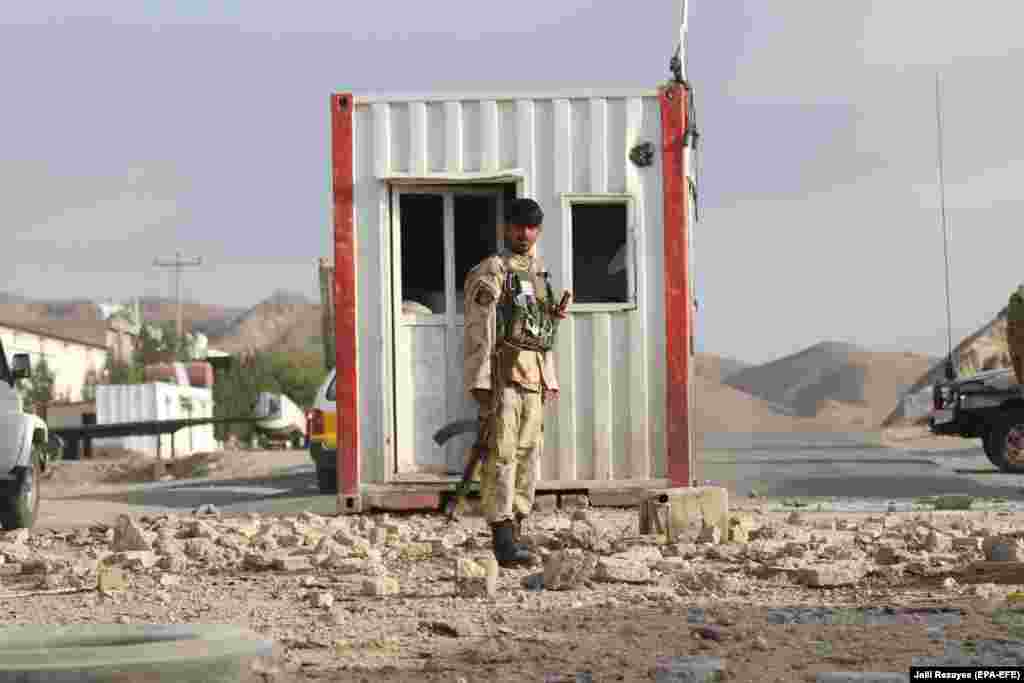 Afghan security officials inspect the scene of a bomb blast that targeted a police checkpoint in Herat Province. At least two police officers were killed and two others injured in the incident. (epa-EFE/Jalil Rezayee)