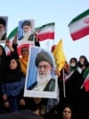 Iranian protesters hold their country's flags and posters of Khamenei in an anti-US and anti-Israeli rally in Tehran, June 24