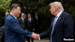 US President Donald Trump shakes hands with Chinese President Xi Jinping after a visit to the Zhongnanhai Garden in Beijing on May 15, 2026.