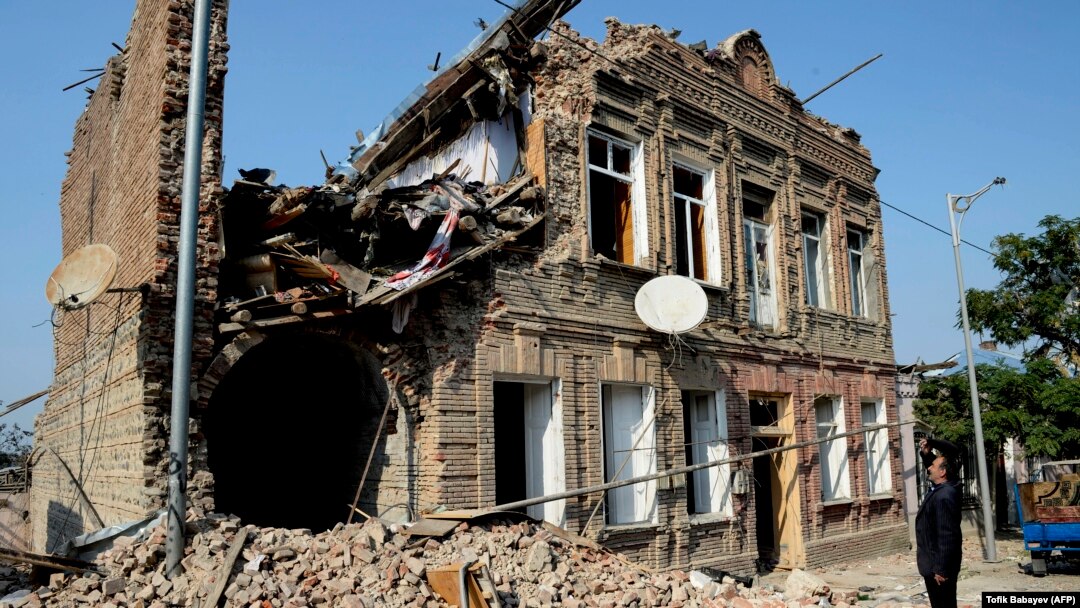 AZERBAIJAN -- A local man looks at a residential building damaged by shelling during the ongoing military conflict between Armenia and Azerbaijan over the breakaway region of Nagorno-Karabakh, in the city of Ganca, on October 27, 2020