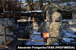 A mechanic fits anti-drone spikes onto a Russian vehicle in Zaporizhzhya.