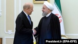 Iranian President Hassan Rohani (right) meets with French Foreign Minister Jean-Yves Le Drian in Tehran on March 5.