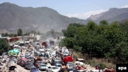 Residents of the restive Swat Valley flee on May 10 after a curfew was temporarily lifted to allow people to escape the intensifying conflict.