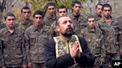 A priest conducts a baptism ceremony for ethnic Armenian soldiers in a military camp near the front line in Nagorno-Karabakh on November 2.