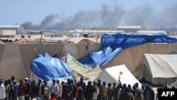 Migrants stand in line as they wait in the besieged Libyan port of Misurata to be evacuated by an International Organization for Migration ship to Benghazi last month.