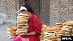 Tajikistan - A girl is selling bread in a market in Panjakent city, Apr2008