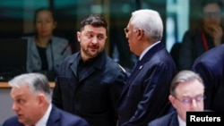 Ukrainian President Volodymyr Zelenskyy (center left) speaks with European Council President Antonio Costa (center right) as they attend a European Union leaders' summit in Brussels, Belgium, December 18, 2025.