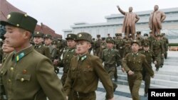 North Korean soldiers visit the bronze statues of North Korea founder Kim Il Sung (left) and late leader Kim Jong Il at Mansudae in Pyongyang on April 15.