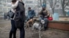 Residents of a heavily damaged 18-story apartment building gather outside following a Russian missile strike in Kyiv and other regions on February 7.