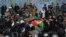 Afghan mourners carry the coffin of one of the six Afghan employees of the Red Cross in Mazar-e Sharif on February 9.