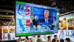 A TV screen showing preliminary results for the U.S. presidential election hangs in a restaurant in Hong Kong on November 6. 