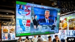 A TV screen showing preliminary results for the U.S. presidential election hangs in a restaurant in Hong Kong on November 6. 