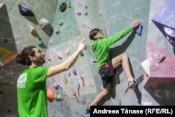 Cristian Vlad, an instructor with Climb Again, instructs a boy during a training session