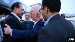 Pakistani Army Chief Syed Asim Munir (left) is greeted by Iranian Interior Minister Eskandar Momeni upon his arrival in Tehran on May 22.