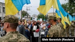 People hold pictures of World War II soldiers as they take part in the Immortal Regiment march during Victory Day celebrations in Kyiv on May 9.