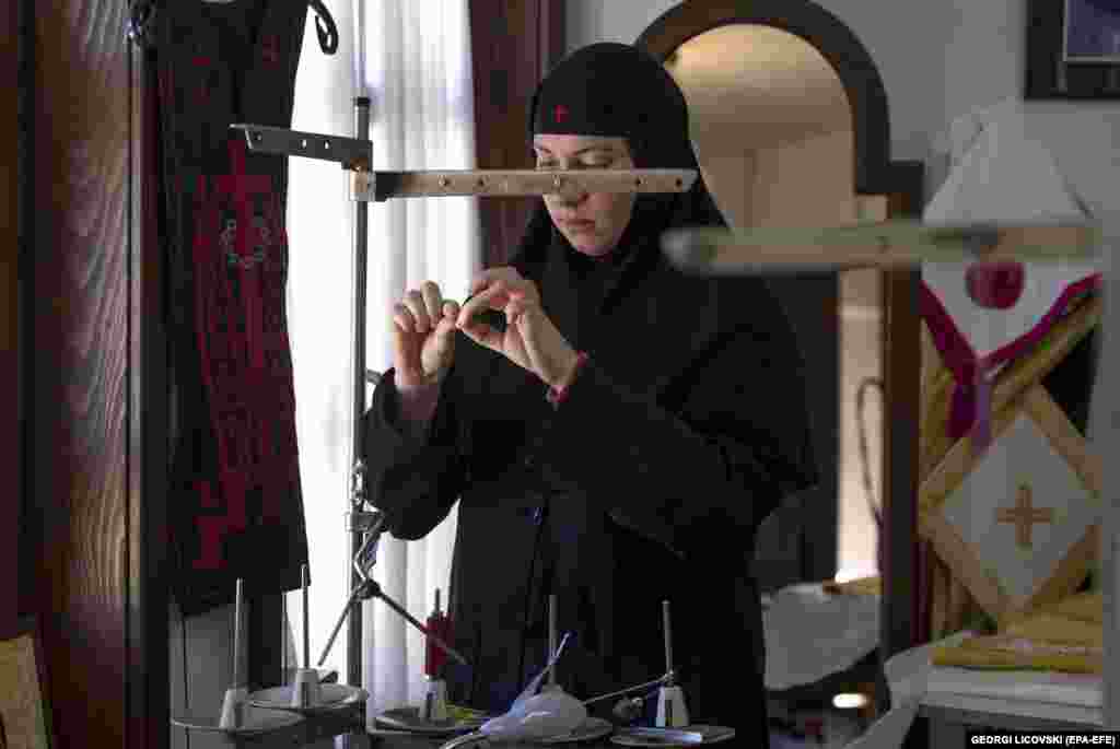 A nun feeds thread into a machine used to embroider the damask fabric of the miter. Each headdress is usually decorated with four icons depicting Jesus, Mary, John the Baptist, and the Holy Cross.&nbsp; &nbsp;