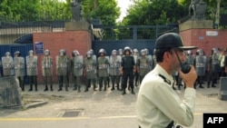 Riot police outside the British embassy in Tehran