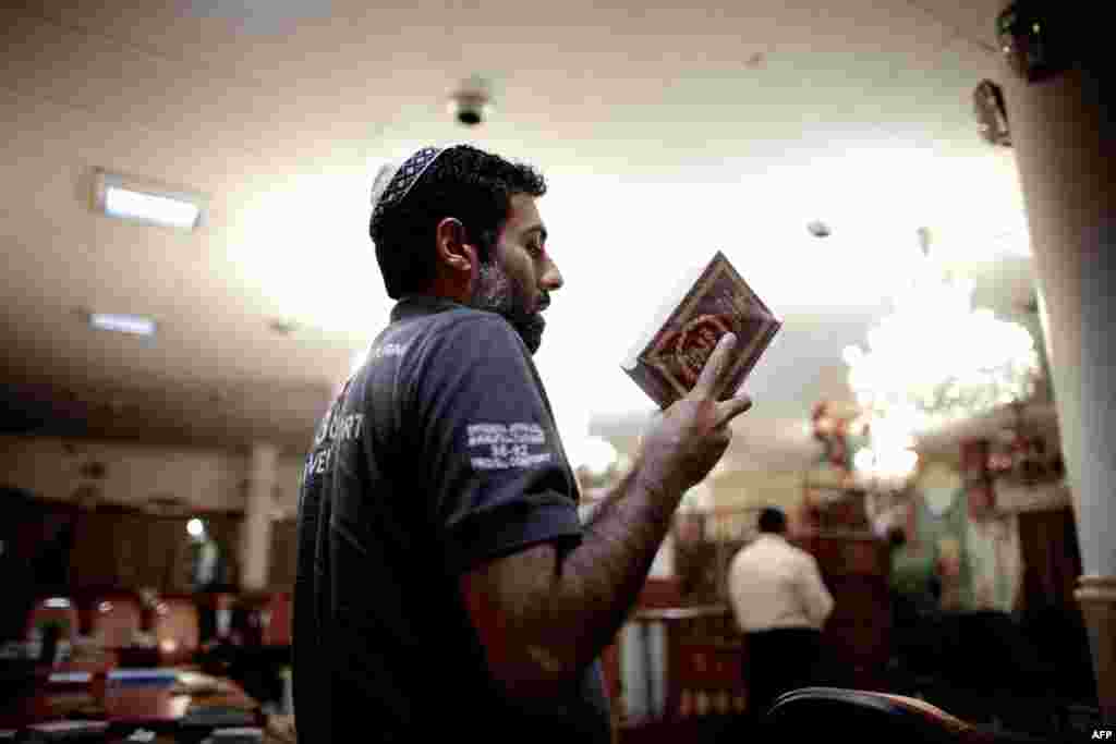 An Iranian Jew reads the Torah at a synagogue in downtown Tehran.