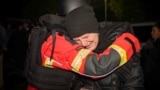 An emergency services psychologist embraces a woman evacuated from an apartment building damaged during Russian missile and drone strikes in Odesa, Ukraine, on November 15. 