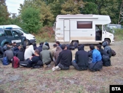 Migrants in Malko Tarnovo sit on the ground during a special police operation on the Bulgarian-Turkish border on September 24.