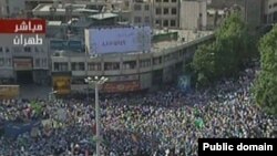 A screen grab from Iranian TV shows thousands of Ahmadinejad supporters rallying in Vali Asr Square in Tehran on June 16.