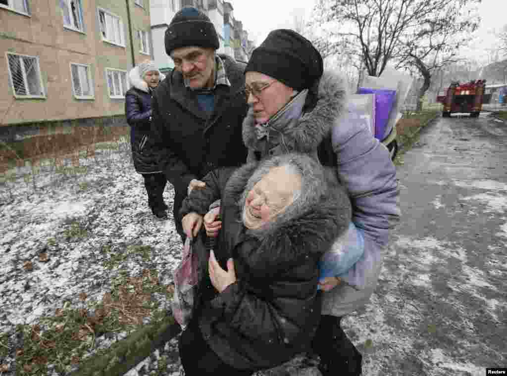 An elderly woman reacts after the residential block in which she lives in was damaged by recent shelling, according to locals, on the outskirts of Donetsk in eastern Ukraine on February 9. (Reuters/Maxim Shemetov)