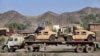 Pakistan -- Drivers stand beside a truck carring Humvee for NATO forces in Afghanistan parked at Torkham border crossing, 28Nov2011