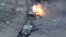 Smoke and fire rise from Russian vehicle during fighting near Synkivka