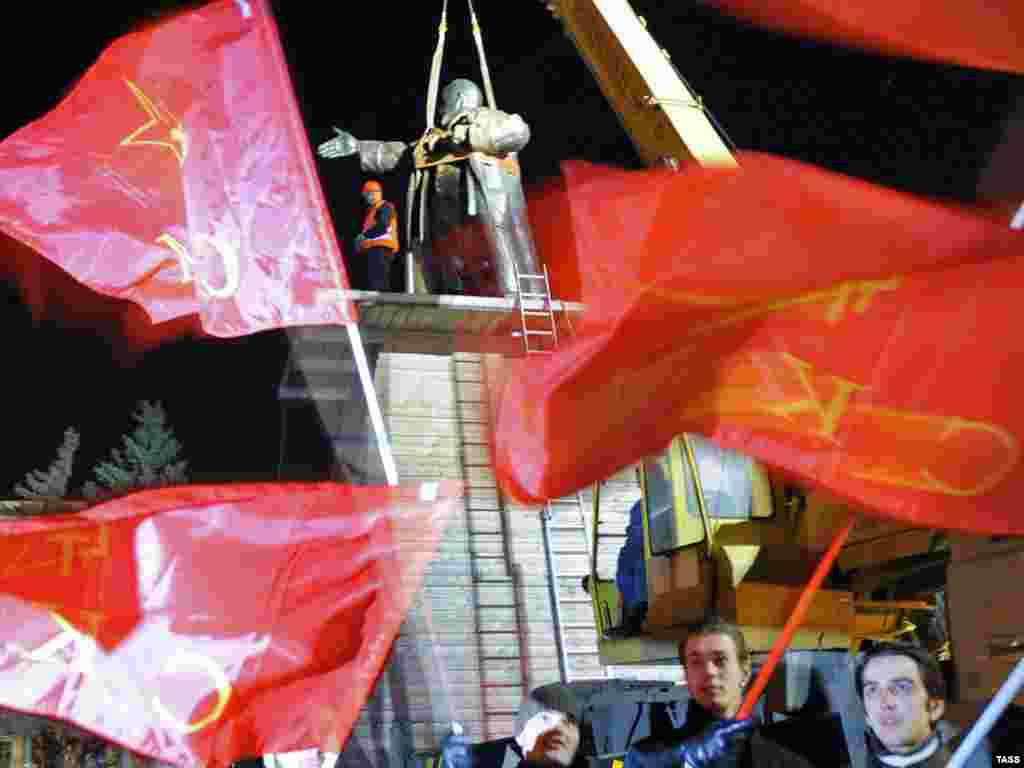 Russian Communist party activists celebrate the installation of a monument to Vladimir Lenin at the Finland Train Station in St. Petersburg on April 15. The bronze statue was restored after it was damaged in an explosion last year. Photo by Ruslan Shamukov for ITAR-TASS.