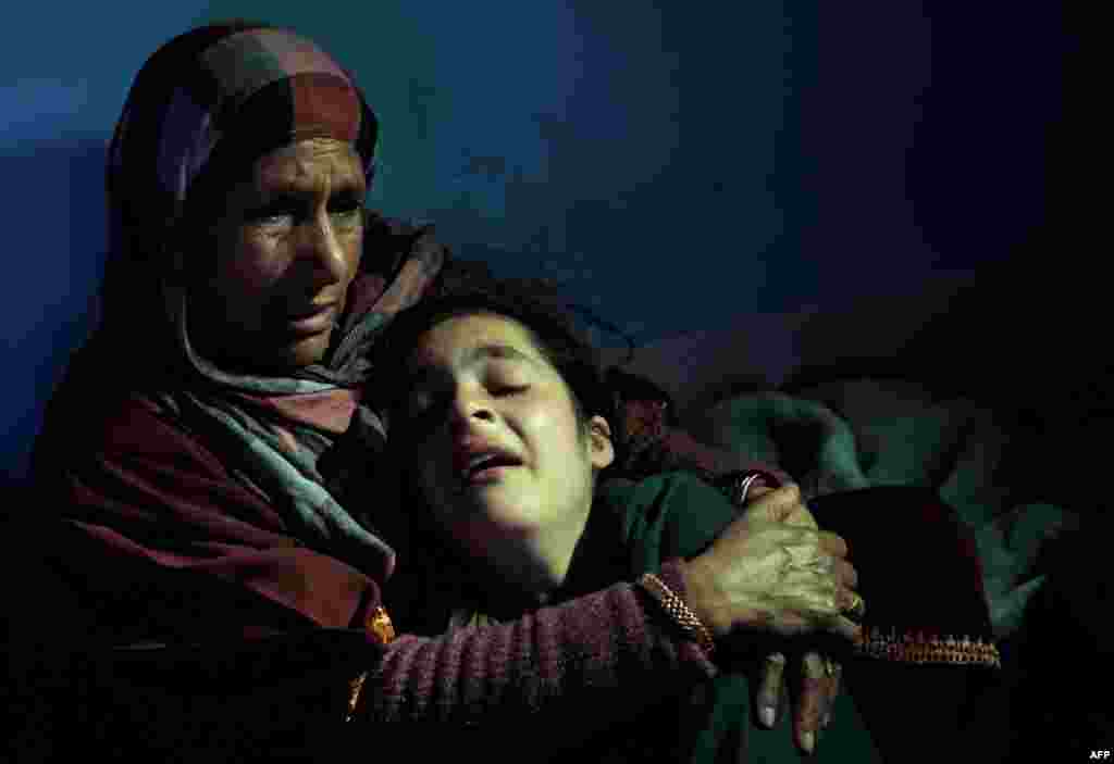 Kashmiri relatives of Raja Bejum, 70, and who was killed in clashes with security forces, mourn during a funeral procession in Langate. Angry residents clashed with police in Indian Kashmir on April 13, one day after three civilians were killed when soldiers fired on protesters incensed by the alleged molestation of a girl. (AFP/Tauseef Mustafa)