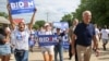 U.S. -- Democratic 2020 U.S. presidential candidate and former Vice President Joe Biden walks with supporters at the Independence Day parade in Independence, Iowa, July 4, 2019.