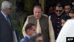 Pakistani Prime Minister Nawaz Sharif (center) leaves with his son Hussain Nawaz (second right) after appearing before an anticorruption commission at the Federal Judicial Academy in Islamabad on June 15.