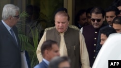 Pakistani Prime Minister Nawaz Sharif (C) leaves with his son Hussain Nawaz (2R) after appearing before an anti-corruption commission at the Federal Judicial Academy in Islamabad on June 15