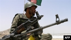 An Afghan soldier keeps watch at a checkpoint in Kandahar.