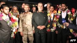 This handout photo provided by Iran's Revolutionary Guard official website via SEPAH News on November 22, 2018 shows Brigadier-General Mohammad Pakpour (C), Commander of the Islamic Revolutionary Guard Corps Ground Forces, receiving five freed Iranian sec